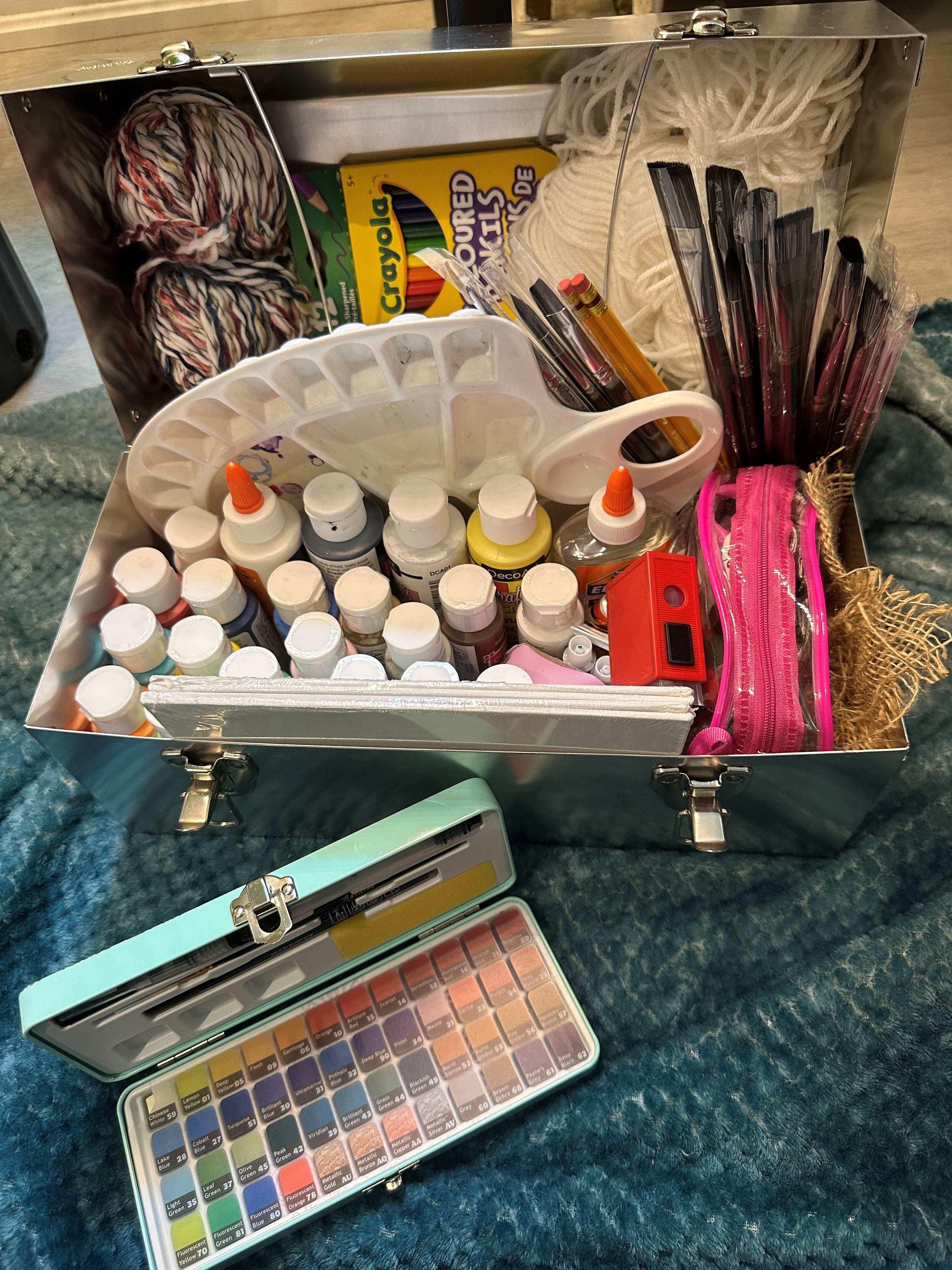 L.May lunchbox with art supplies. Paint, brushes, crafts