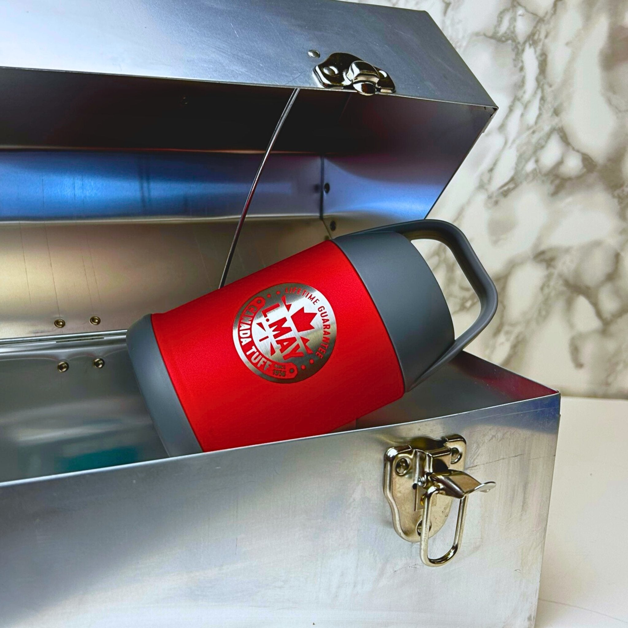 Close-up of the L. May 'tuff' lunchbox, featuring durable aluminum construction and timeless design with the chilly moose tamarack inside