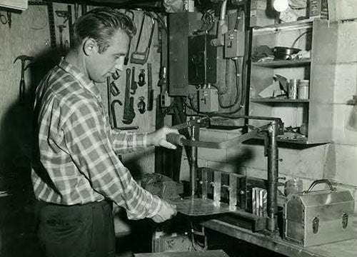 Leo may working on his basement building an L. May metal lunchbox