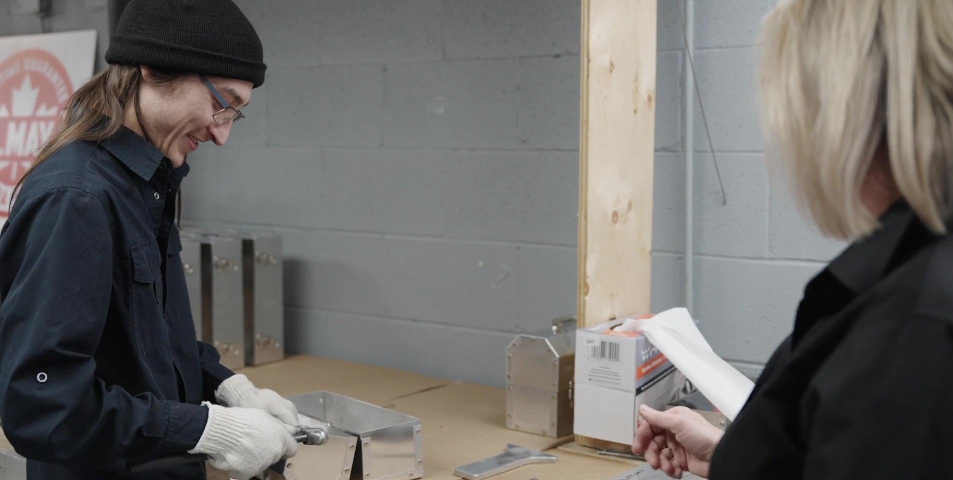 L. May staff in the L. May shop building metal lunchboxes