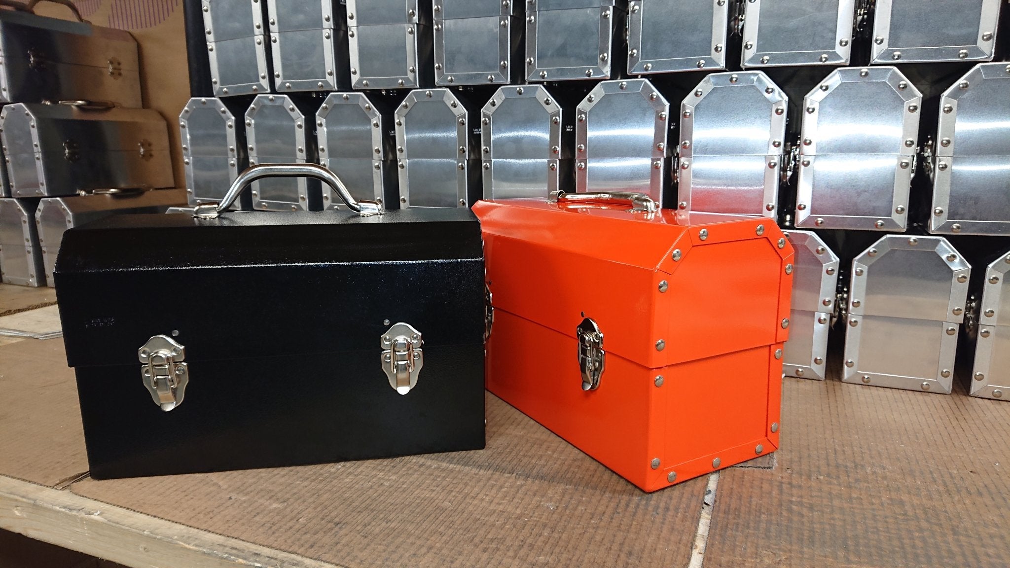 black hammered lunchbox with an orange safety metal lunchbox from L. May
