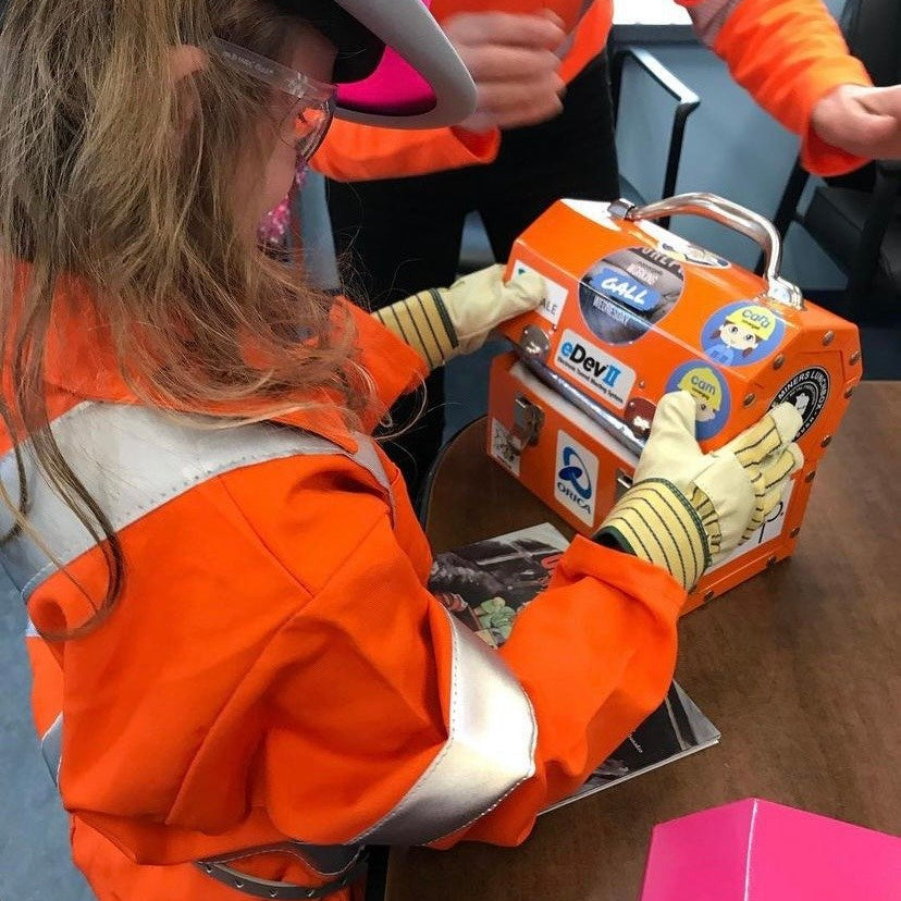 alicia woods from covergalls with a kids workwear holding an L. May pink lunchbox