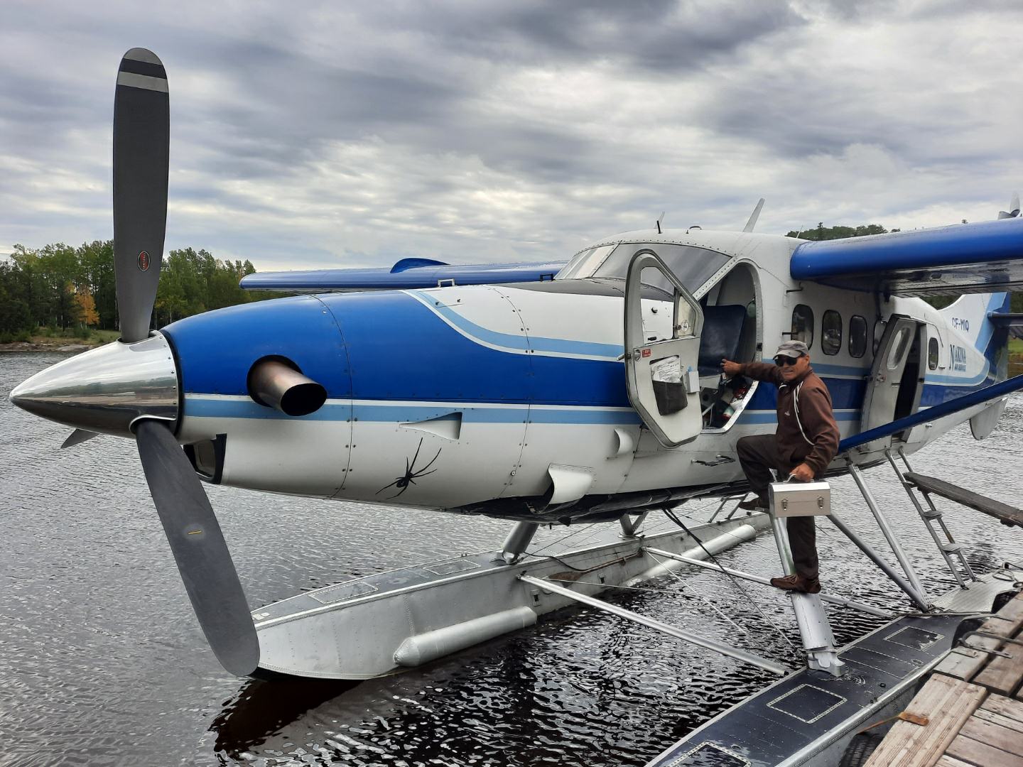 a canadian on a seaplane carrying an L. May metal lunchbox