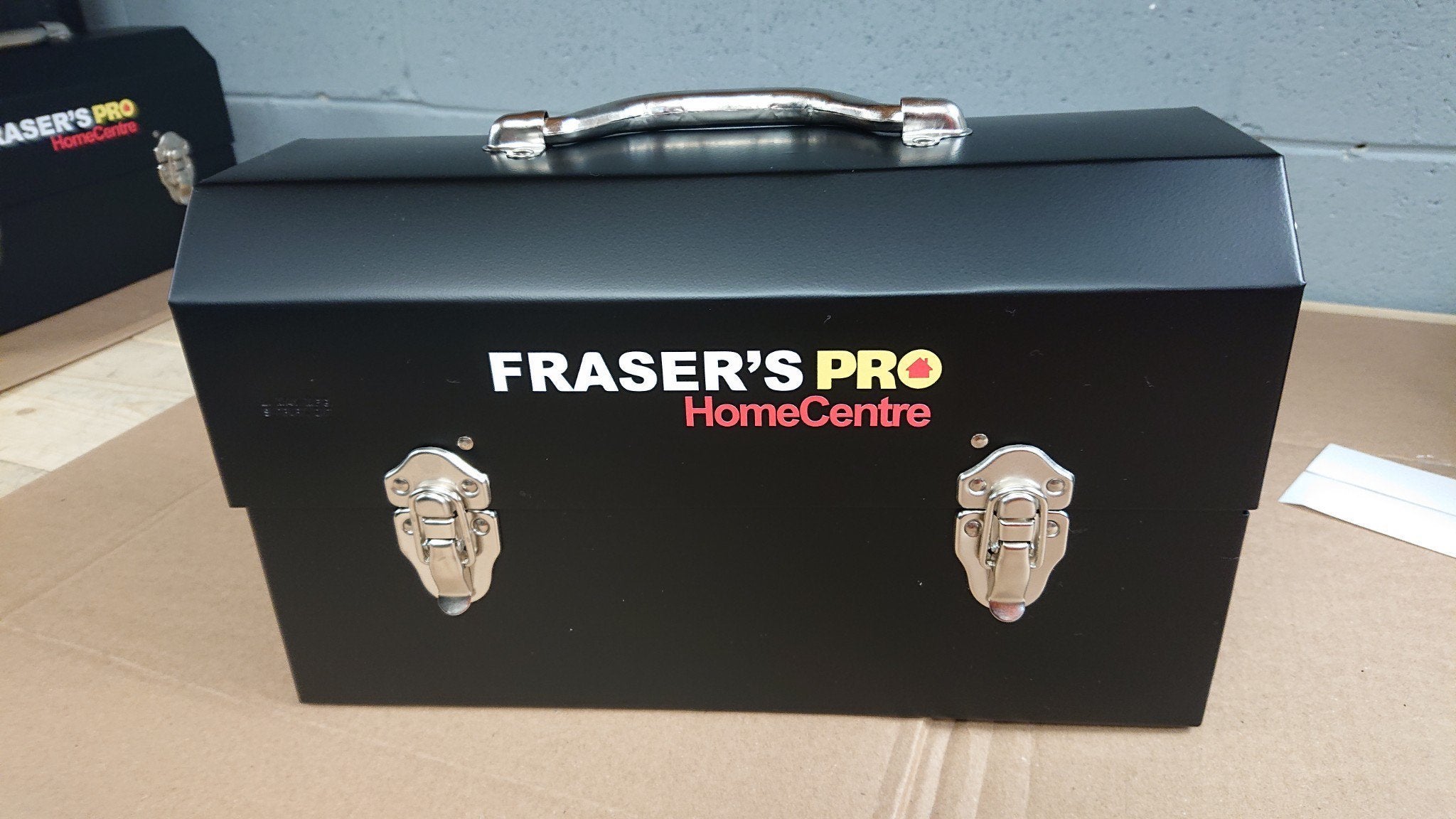 cut letter sticker with fraser's pro homecentre logo on a matte black L. May lunchbox