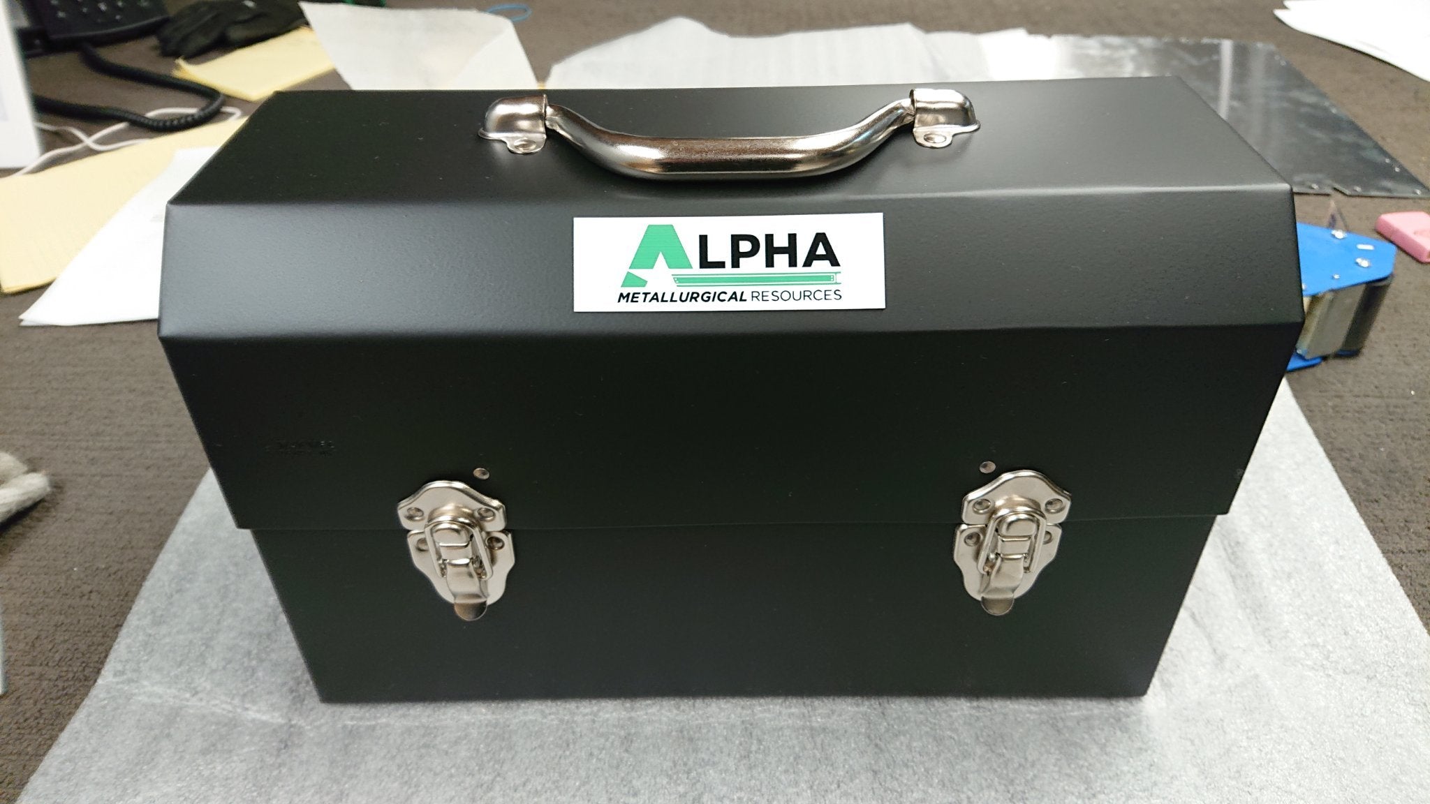 alpha plate on a matte black L. may metal lunchbox