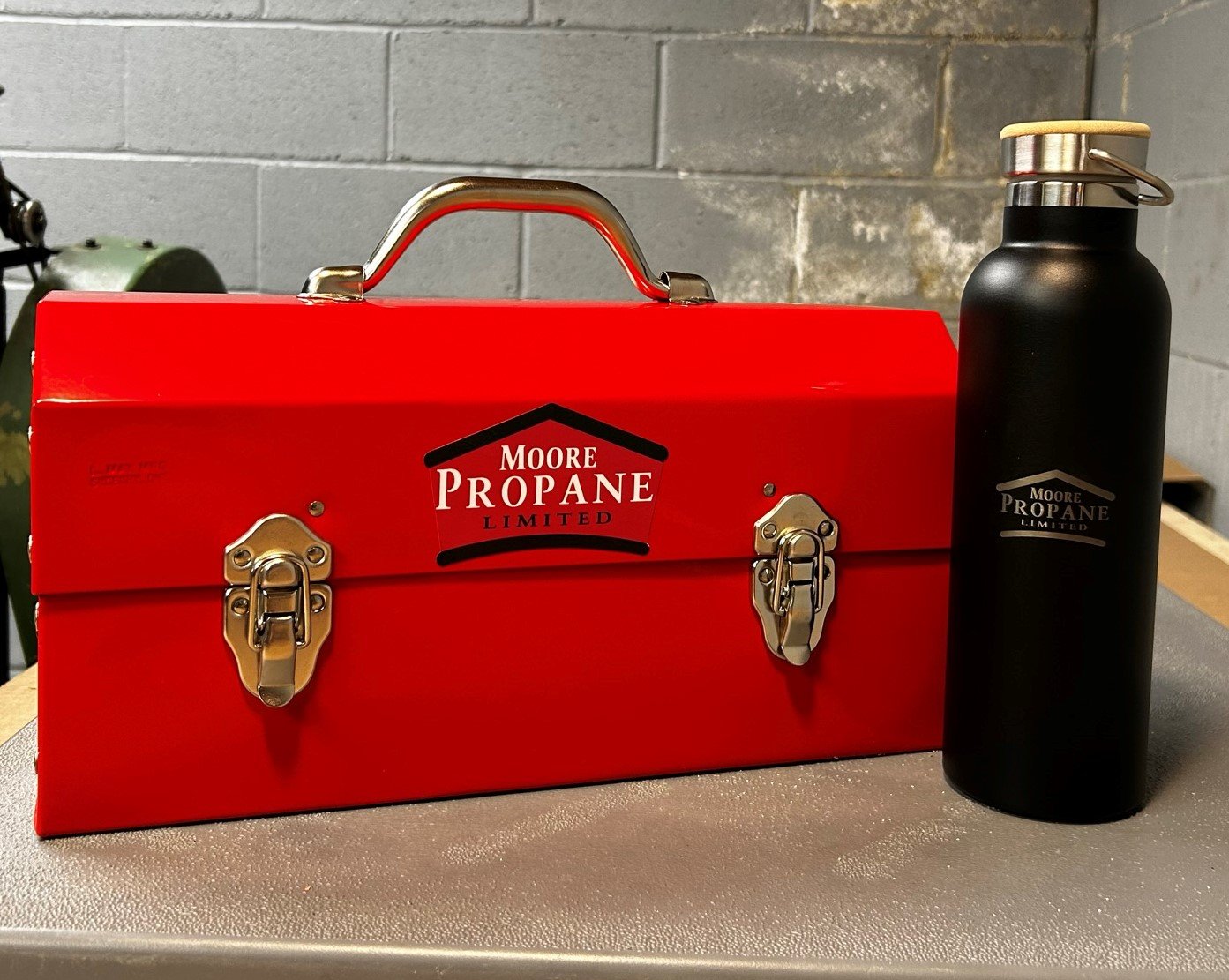 moore propane sticker on a red L. may lunchbox